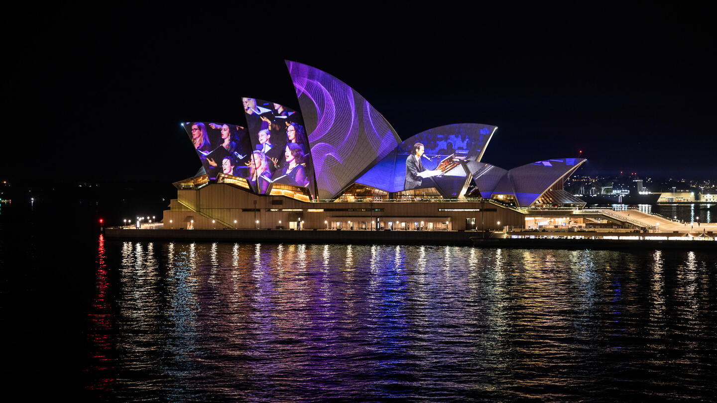 Photo of the Sydney Opera House with projection mapping across its sails