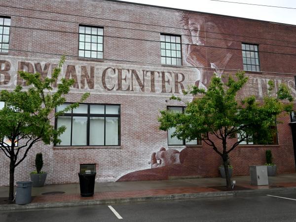 The exterior building of the new Bob Dylan Center showing a mural of the musical icon.