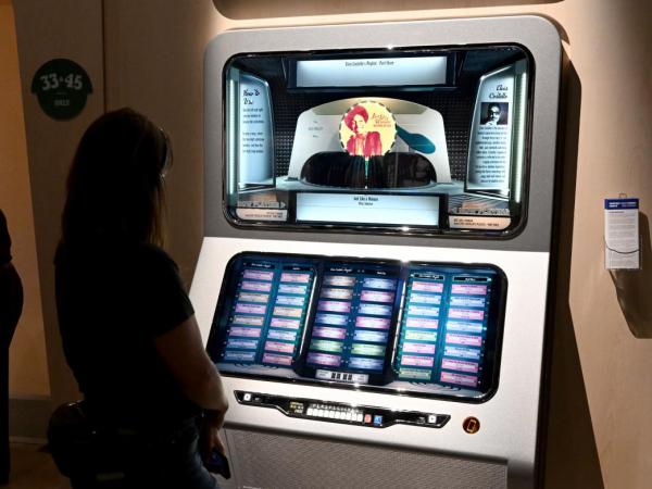 A woman listens to audio played by the Jukebox interactive at the Bob Dylan Center.