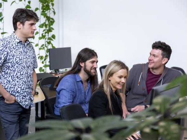 Group of people sitting and talking in an office setting