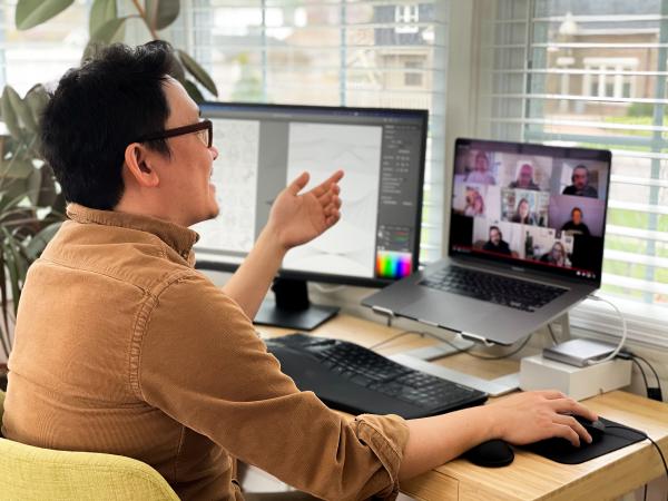 Man working from home having a group video call meeting