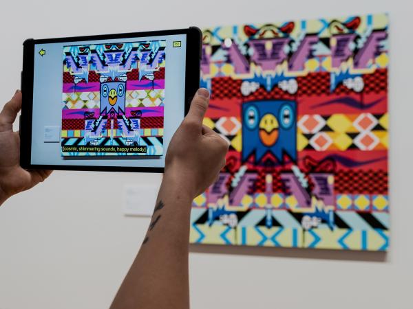 Photo of Augmented reality on iPad looking at artwork at the Josh Muir Exhibition at Bendigo Art Gallery