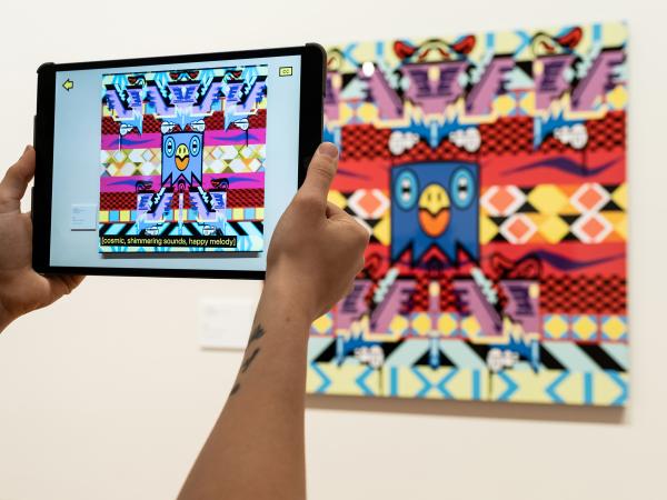 Augmented reality and audio experience shown on an iPad with close captions at the Bendigo Art Gallery
