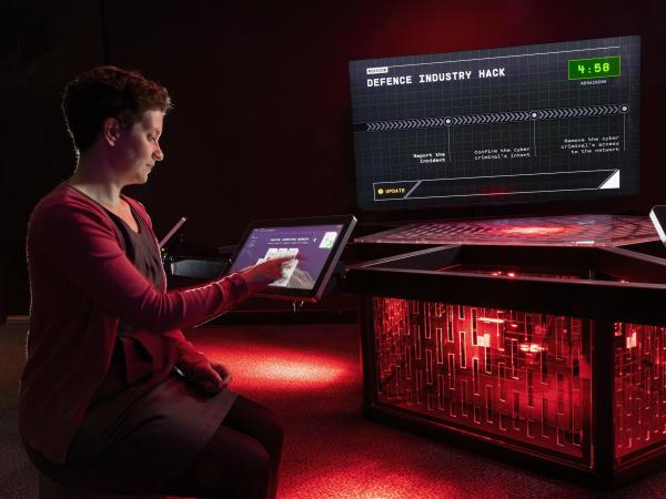 A woman plays an original game Art Processors created for the Decoded exhibition at the National Museum of Australia