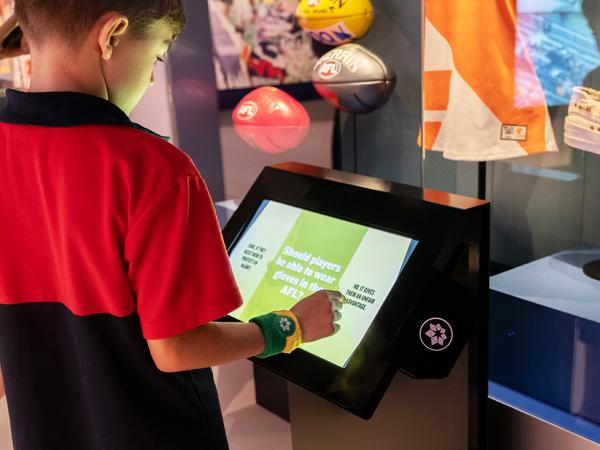 Student using interactive touch panel at Australian Sports Museum Melbourne