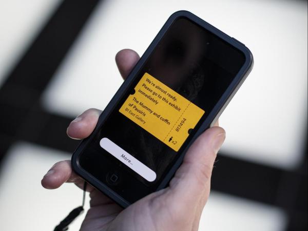 The virtual queuing interface on the O summoning a visitor to the exhibit