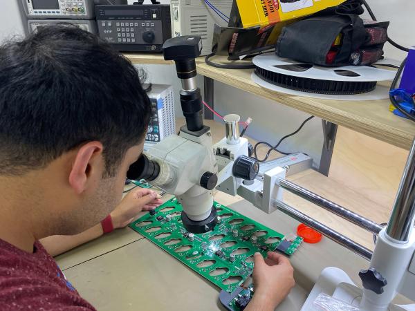 Electronic Engineer Sahil Khanna inspecting the TAPX iPod charging units