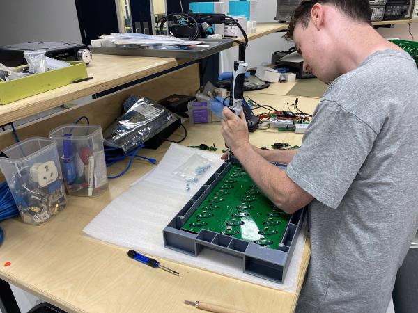 Industrial Designer Charles O’Connor putting the finishing touches on TAPX iPod charging units