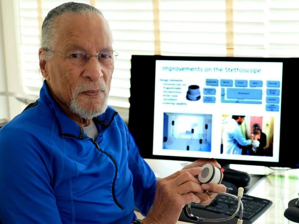 Johns Hopkins School of Engineering Professor Dr. James Edward Maceo West featured with a prototype of his research group's latest invention, a smart digital stethoscope with artificial intelligence algorithms.