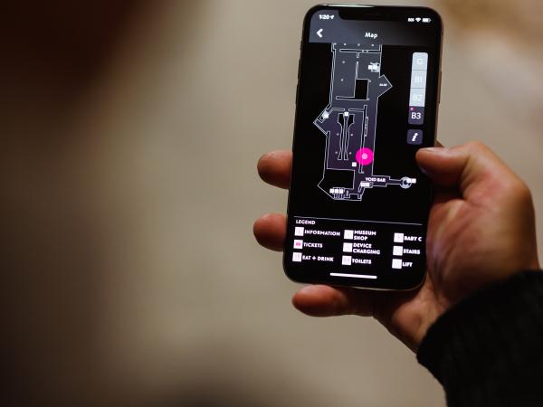 A map of the Museum of Old and New Art is displayed on a mobile device, showing the holder where in the museum they are