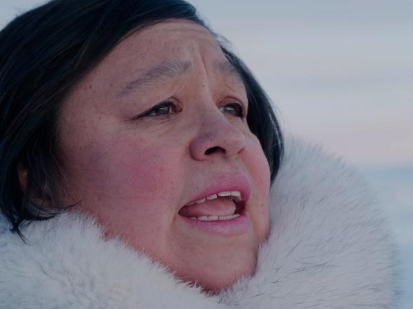 Singer Looee Arreak from Against the Grain Theatre performing in the snowy natural landscape of Canada.