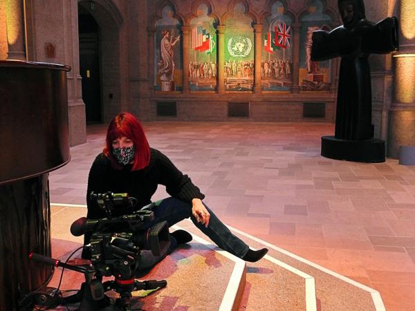 Art Processors Content Director Christine Murray using a video camera inside Grace Cathedral in San Francisco.