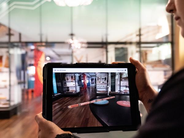 An iPad screen showing a 3D didgeridoo as part of the augmented reality experience at Awaken