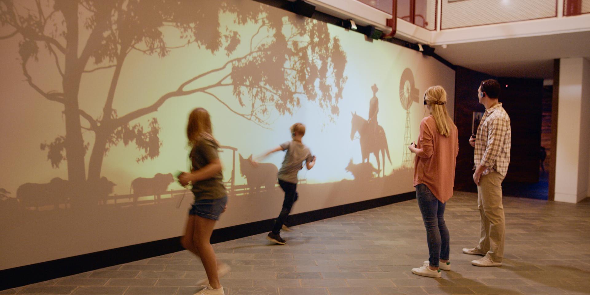 Children interact with an animated projection of an outback station at the Australian Stockmans Hall of Fame