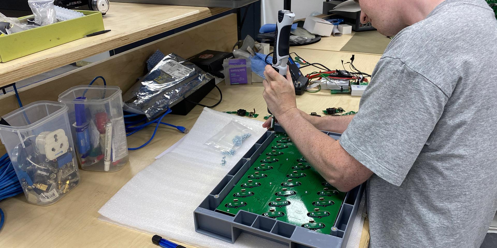 Industrial Designer Charles O’Connor putting the finishing touches on TAPX iPod charging units
