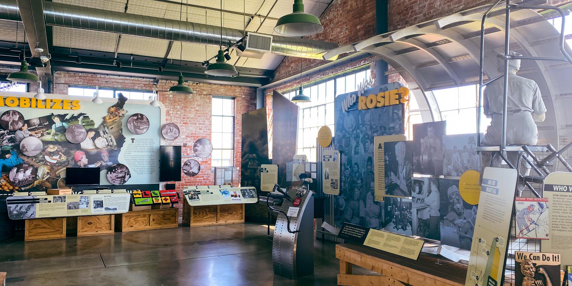 Interior of the Rosie the Riveter exhibition at the National Park Service showing historical displays of World War II factories