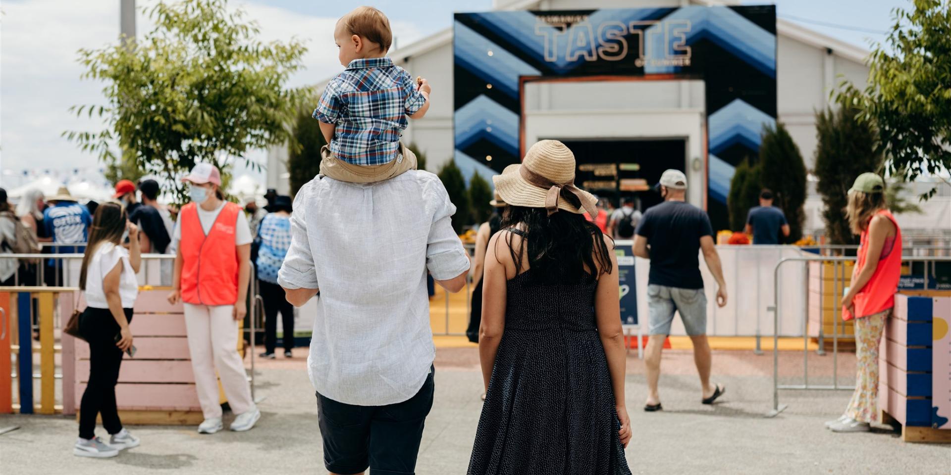 A family enters the Taste of Summer festival.