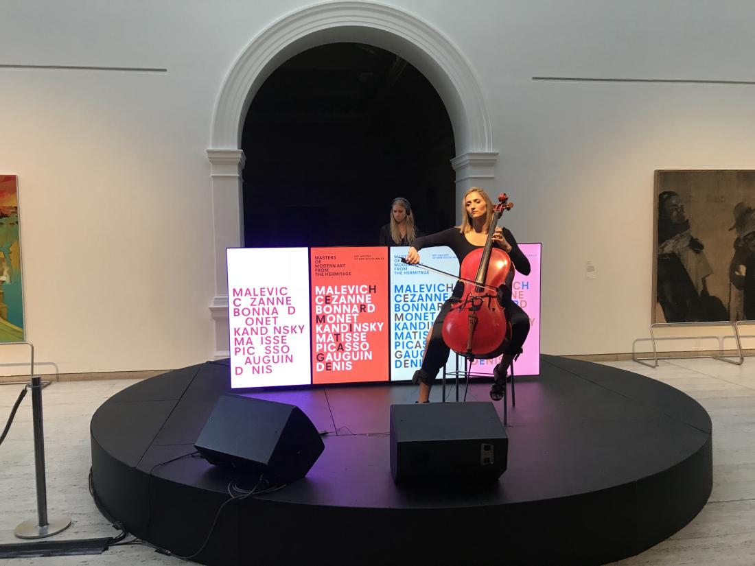 A woman plays cello at the launch party of Masters of Modern Hermitage exhibitio