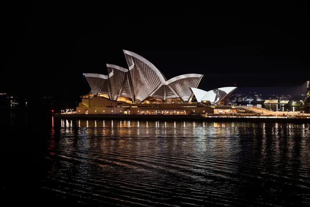 The Sydney Opera House at night, with projection mapping across its sails